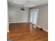 Bright living room featuring vinyl floors, a decorative light fixture, and access to outdoor space at 3818 Mulkey Sw Cir, Marietta, GA 30008