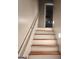 Stairway with wooden treads, white risers, and a handrail leading to an upper level at 3818 Mulkey Sw Cir, Marietta, GA 30008