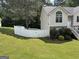 View of expansive, fenced backyard and side of home with traditional architectural details at 85 Creekside Trl, Covington, GA 30016