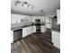 Updated kitchen featuring white cabinets, stainless steel appliances and tile backsplash at 85 Creekside Trl, Covington, GA 30016