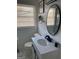Bright bathroom featuring a modern vanity, an oval mirror, and a window with blinds at 3385 M L King Jr Sw Dr, Atlanta, GA 30331