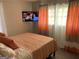 Comfortable bedroom with a cozy bed, stylish decor, and a mounted TV for relaxing evenings at 3385 M L King Jr Sw Dr, Atlanta, GA 30331