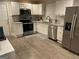 Modern kitchen with stainless steel appliances, white cabinets, granite countertops, and stylish backsplash at 3385 M L King Jr Sw Dr, Atlanta, GA 30331