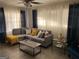 Cozy living room with a comfortable gray sectional sofa, stylish decor, and ample natural light from large windows at 3385 M L King Jr Sw Dr, Atlanta, GA 30331