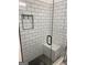 Modern shower with black framed glass door, subway tile walls, and a comfortable shower bench at 3385 M L King Jr Sw Dr, Atlanta, GA 30331