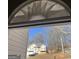 View of a yellow house with blue shutters and a blue car in the driveway, seen from behind another doorway at 213 Bonnie Sue Dr, Villa Rica, GA 30180