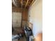 View of garage interior with exposed framing, a closed white door, and stored items creating a cluttered scene at 213 Bonnie Sue Dr, Villa Rica, GA 30180