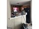 View of the kitchen area with wooden cabinets and a black refrigerator at 213 Bonnie Sue Dr, Villa Rica, GA 30180