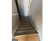 Carpeted staircase leading downstairs with a wood landing and a white door at 213 Bonnie Sue Dr, Villa Rica, GA 30180