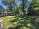 Spacious backyard featuring a well-maintained lawn, patio area, and a privacy fence at 4080 Longford Ne Dr, Marietta, GA 30066