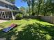 Private backyard featuring a large lawn area, screened porch, and wooden fence at 4080 Longford Ne Dr, Marietta, GA 30066
