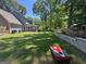 Expansive backyard with lush lawn, screened-in porch, and cornhole game set at 4080 Longford Ne Dr, Marietta, GA 30066