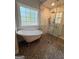 Bathroom featuring a glass-enclosed shower with modern fixtures and mosaic tile flooring at 4080 Longford Ne Dr, Marietta, GA 30066