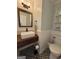 Chic half bath features patterned tile flooring and wooden fixtures at 4080 Longford Ne Dr, Marietta, GA 30066