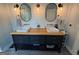 Modern bathroom with dual sinks, a wood countertop, and decorative lighting fixtures at 4080 Longford Ne Dr, Marietta, GA 30066