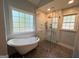 Luxurious bathroom with a freestanding tub and a glass-enclosed shower with modern fixtures at 4080 Longford Ne Dr, Marietta, GA 30066