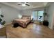 Bright bedroom featuring hardwood floors, a ceiling fan, and natural light from the windows at 4080 Longford Ne Dr, Marietta, GA 30066