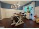 Dining room with dark hardwood floors, wainscoting, and modern chandelier lighting at 4080 Longford Ne Dr, Marietta, GA 30066