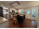 Bright kitchen boasts white cabinets, stainless appliances, wood floors, and center butcher block island at 4080 Longford Ne Dr, Marietta, GA 30066