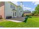 Spacious backyard features a large stone patio, lush lawn and mature trees at 1120 Twin Bridge Ln, Peachtree City, GA 30269