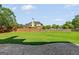 Spacious backyard features a large lawn, stone patio and mature trees at 1120 Twin Bridge Ln, Peachtree City, GA 30269
