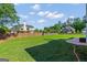 The backyard boasts a large, well-maintained lawn, wooden fences, and mature trees at 1120 Twin Bridge Ln, Peachtree City, GA 30269