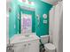 Bright and inviting bathroom with a turquoise painted wall and a decorative mermaid theme at 1120 Twin Bridge Ln, Peachtree City, GA 30269