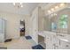 Bright bathroom featuring double vanity sinks, tile flooring, and a large mirror at 1120 Twin Bridge Ln, Peachtree City, GA 30269