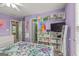 A cheerful bedroom showcases purple walls, white furniture, and unique shelving, providing both storage and style at 1120 Twin Bridge Ln, Peachtree City, GA 30269