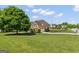 Brick two-story home with attached garage, lush lawn, mature tree, and tasteful landscaping on a large lot at 1120 Twin Bridge Ln, Peachtree City, GA 30269