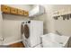 Convenient laundry room with washer, dryer, sink, and storage shelves at 1120 Twin Bridge Ln, Peachtree City, GA 30269