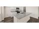 Close-up of kitchen island featuring gray granite countertops and stainless steel sink at 620 Whitman Ln # 31, Stockbridge, GA 30281