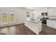 Modern kitchen featuring stainless steel appliances, an island with sink, and white cabinetry at 620 Whitman Ln # 31, Stockbridge, GA 30281