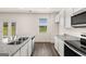 Modern kitchen featuring stainless steel appliances, granite countertops, and double sink with a window view at 620 Whitman Ln # 31, Stockbridge, GA 30281