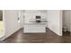 Modern kitchen featuring stainless steel appliances, an island with sink, and white cabinetry at 620 Whitman Ln # 31, Stockbridge, GA 30281