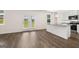 Open-concept kitchen and living room area with hardwood floors and abundant natural light at 620 Whitman Ln # 31, Stockbridge, GA 30281