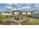 Community playground surrounded by green grass and mature trees provides a safe play area for children at 620 Whitman Ln # 31, Stockbridge, GA 30281