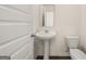 Bright powder room features a pedestal sink, toilet, and a mirror at 620 Whitman Ln # 31, Stockbridge, GA 30281