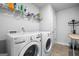 Well-equipped laundry room with modern washing machines and storage shelving at 150 Gadson Dr, Fayetteville, GA 30214