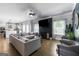 Spacious living room with a fireplace, tv, hardwood floors, and an open concept kitchen in the background at 150 Gadson Dr, Fayetteville, GA 30214