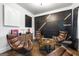 Modern living room with unique wall decor, hardwood floors, and comfortable leather chairs at 150 Gadson Dr, Fayetteville, GA 30214