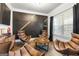Cozy living room featuring modern wall decor, hardwood floors, and comfortable leather chairs by a window at 150 Gadson Dr, Fayetteville, GA 30214