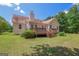 Enjoy outdoor living with a spacious wooden deck, mature trees, and well-maintained lawn at 3533 Saddlebrook Dr, Loganville, GA 30052