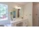 Bright bathroom with a decorative stained-glass window and a spacious vanity at 3533 Saddlebrook Dr, Loganville, GA 30052