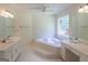 Bathroom features dual vanities, a jacuzzi tub, and a stained glass window at 3533 Saddlebrook Dr, Loganville, GA 30052