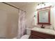 Cozy bathroom with a shower/tub combo and vanity with a framed mirror at 3533 Saddlebrook Dr, Loganville, GA 30052
