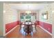 Dining room features a table with four chairs, a chandelier, and bright wall coverings at 3533 Saddlebrook Dr, Loganville, GA 30052