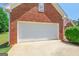 Attached garage with a clean, white door and spacious driveway at 3533 Saddlebrook Dr, Loganville, GA 30052
