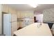 Bright kitchen with white appliances, countertop, cabinets, and views of other rooms at 3533 Saddlebrook Dr, Loganville, GA 30052