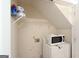 Laundry area equipped with shelving, a microwave, and a washer/dryer at 3533 Saddlebrook Dr, Loganville, GA 30052
